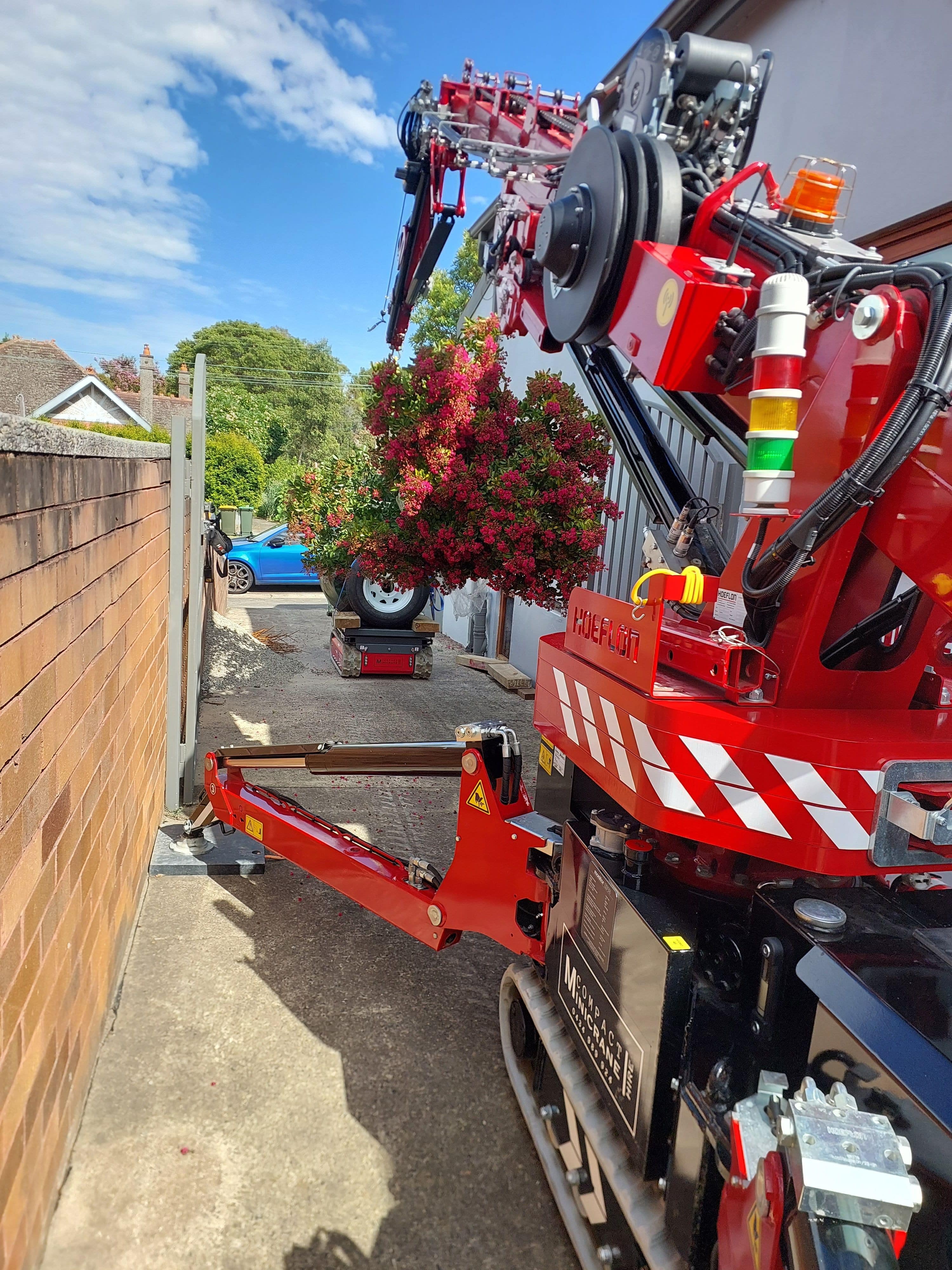 Hoeflon C6 Paired With The Tracked Carrier 1200 Pro To Move A Large Tree Towards The Rear Of A Property.